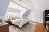 Bedroom 3 on the second level featuring hardwood flooring and a window with blinds