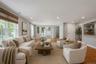 Spacious family room area featuring wood-finish flooring, recessed lighting, and a neutral color palette