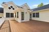 Expansive outdoor deck featuring wood-finish flooring and white railing
