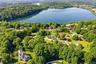 Elevated aerial perspective showcasing a residential area with a prominent body of water