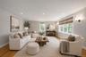 Living area featuring wood-finish flooring, recessed lighting, and expansive windows