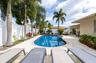 Freeform swimming pool surrounded by a paver patio
