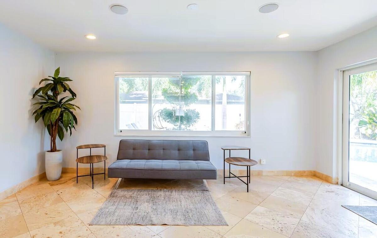 Spacious interior featuring large format tile flooring, recessed lighting, and a large window providing ample natural light