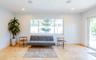 Spacious interior featuring large format tile flooring, recessed lighting, and a large window providing ample natural light
