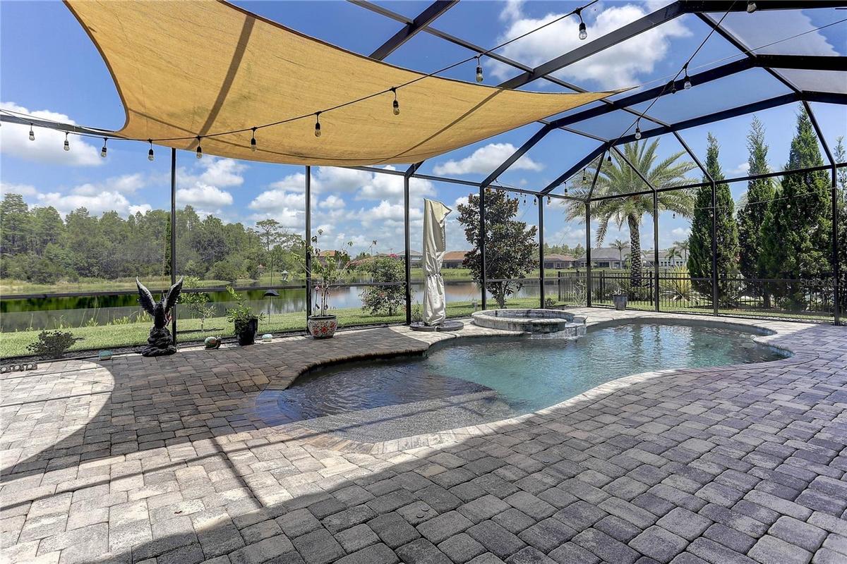 Pool, spill over spa, pavers, pond