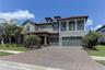 Front showing 3 car garage and paver driveway