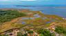 Aerial view of property and surrounding area featuring a large body of water