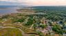 Aerial perspective of suburban area featuring a large body of water