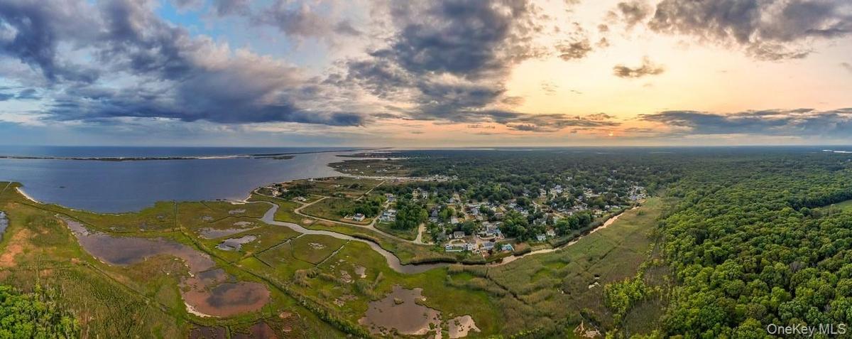 Aerial overview of property's location with a large body of water