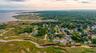 Aerial view of property's location featuring a large body of water and nearby suburban area