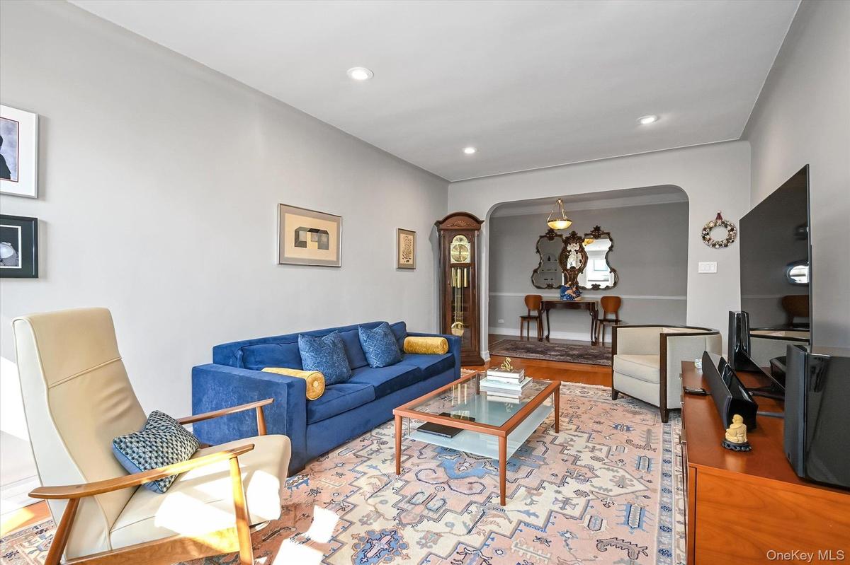 Living room with 10 foot ceiling and recessed lighting, equipped with 3 dimming switches. and beautifully renovated and maintained hardwood floors
