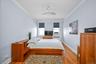 2nd bedroom easily accommodates a queen-size bed with refinished hardwood floors