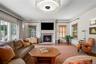 Living room/family room featuring a brick fireplace with sliding glass door leading to the back patio