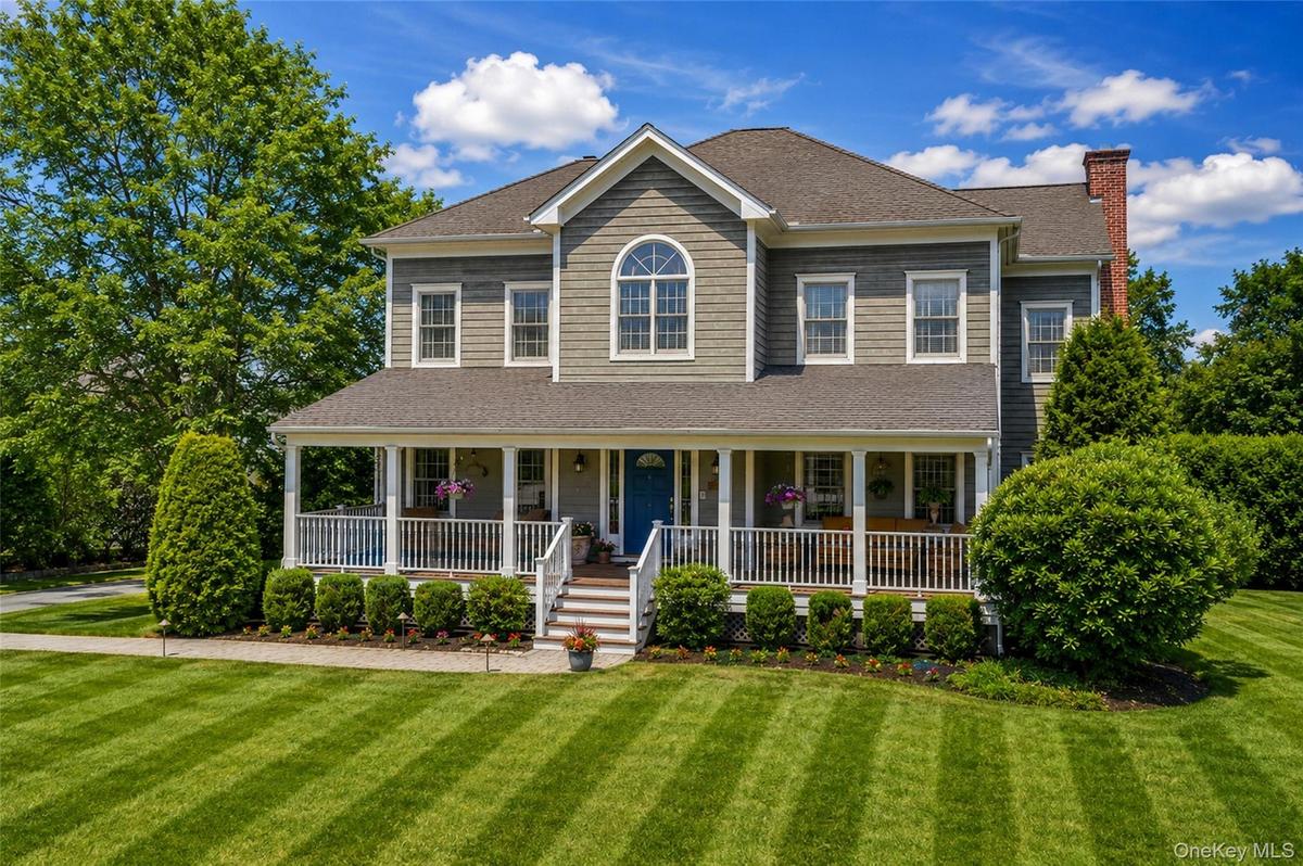 Expansive colonial-style residence featuring a broad front porch
