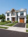 Contemporary residential exterior featuring white vertical siding and stone accents
