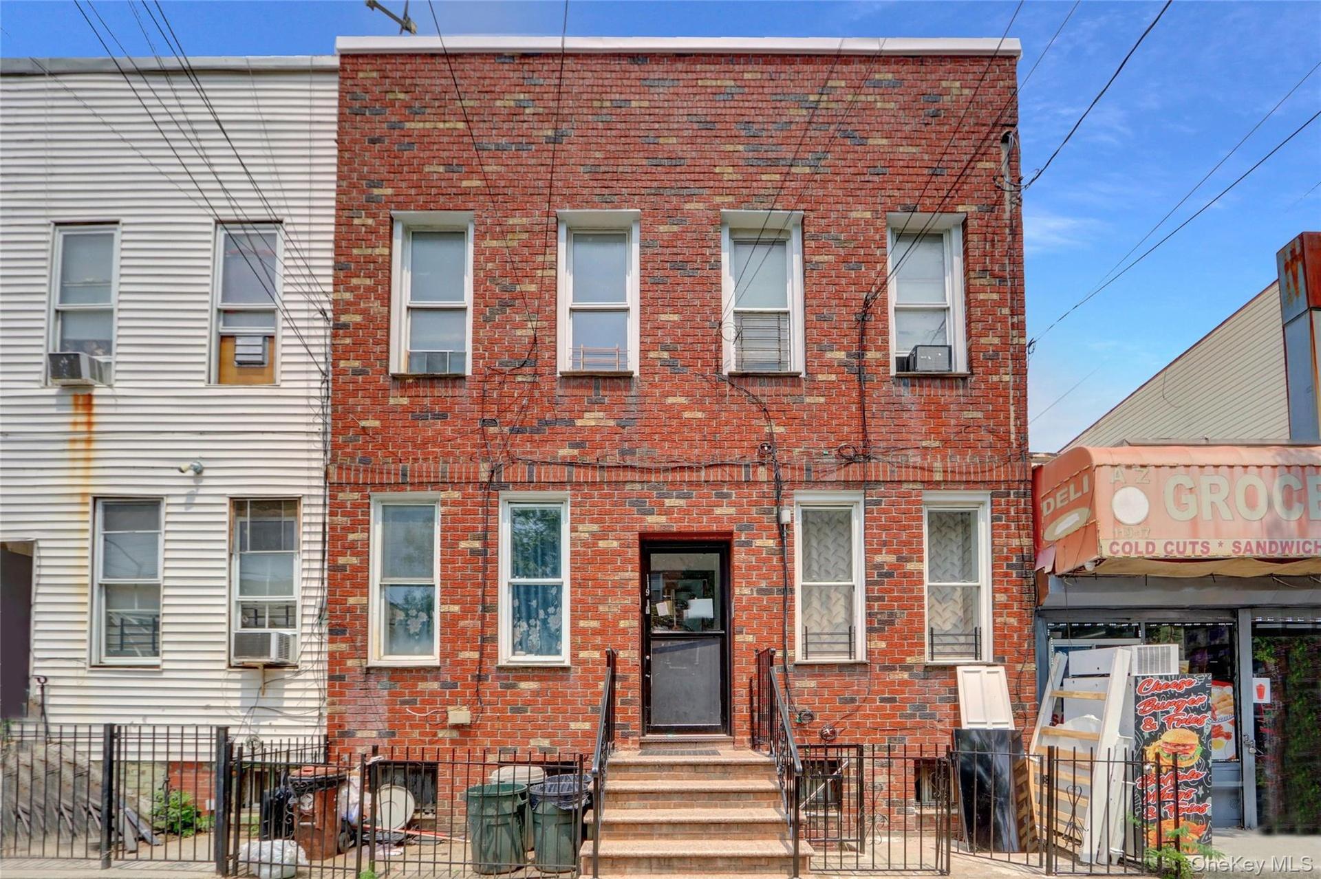 Brick facade property featuring multiple windows and a central entrance