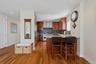 Modern kitchen featuring wood-finish flooring, recessed lighting, and stainless steel appliances