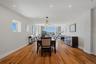 Open-concept living area featuring wood-finish flooring, recessed lighting, and expansive windows