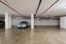 2 Dedicated parking spaces within a subterranean garage, featuring polished concrete flooring and overhead utility lines