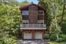 Split-level exterior featuring wood siding, balcony, and shake accents