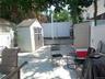 Paved patio area featuring two storage sheds