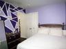 Room featuring a geometric accent wall in shades of purple