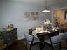 Dining area featuring dark wood-finish flooring, light gray wall paint, and a modern pendant light fixture