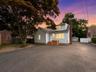 Twilight enhanced. Front of the house. Deep parking - 2 car garage towards the back with additional storage.