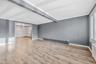 Unfurnished room with crown molding, light wood finished floors, a baseboard radiator, beam ceiling, and radiator