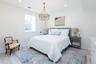 Bedroom with light wood-style floors, recessed lighting, and a chandelier