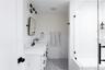 Full bathroom with tile walls, vanity, a stall shower, wainscoting, and light tile patterned floors