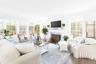Living area featuring plenty of natural light, wood finished floors, and ornamental molding