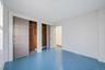 Unfurnished bedroom featuring hardwood / wood-style floors, multiple closets, and ornamental molding