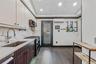 Kitchen with double oven range, dark brown cabinets, modern cabinets, dark wood-style floors, and recessed lighting