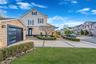 View of front of house featuring a front yard, a garage, and a residential view