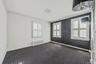 Unfurnished room featuring ornamental molding, radiator, healthy amount of natural light, and dark colored carpet