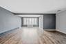 Empty room featuring radiator, light wood-style floors, and ornamental molding