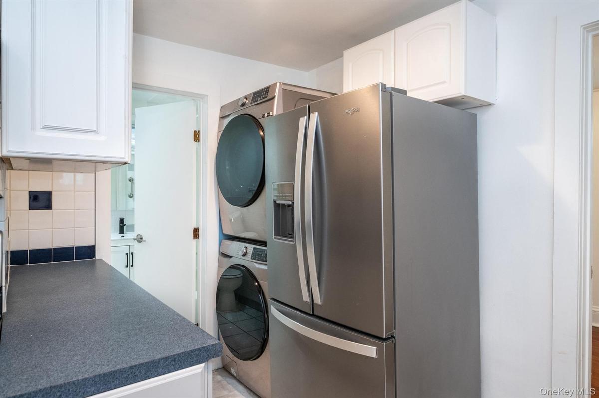 Kitchen with washer & dryer looking into the bathroom