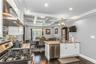 This kitchen is a SHOWSTOPPER! Lovingly designed with white cabinets, quartz countertops, and stainless steel appliances