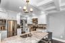 This kitchen is a SHOWSTOPPER! Lovingly designed with white cabinets, quartz countertops, and stainless steel appliances