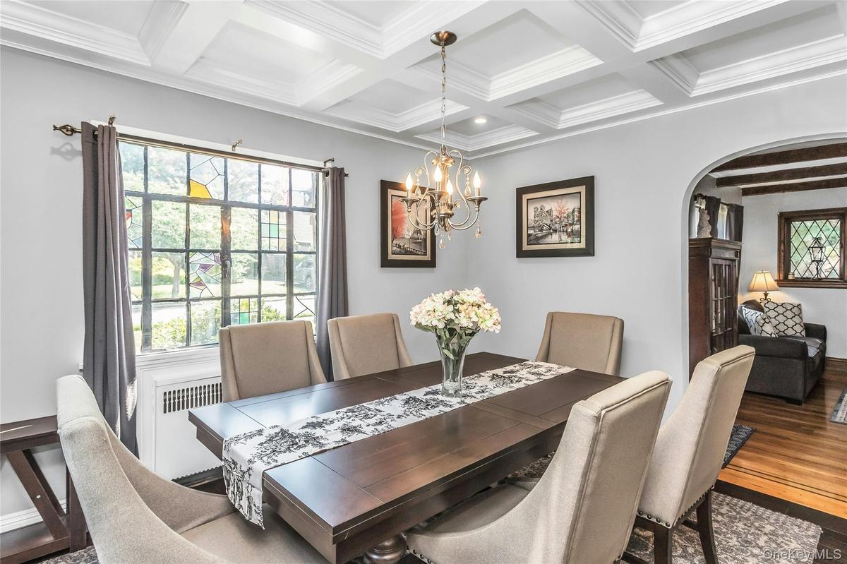 Open Floorplan Dining Room with coffered ceiling off of the Living room and opens to the beautifully designed Kitchen