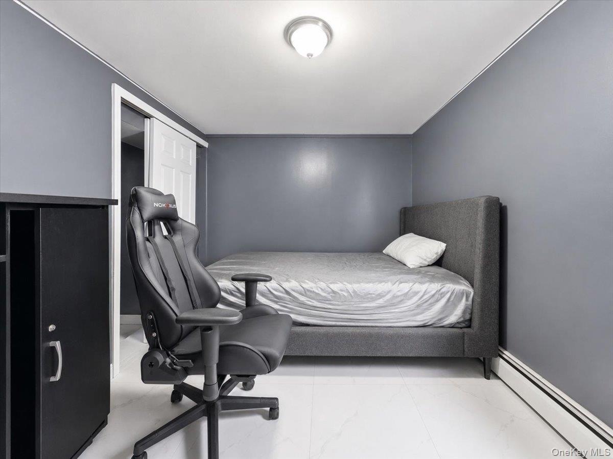 Interior room featuring light gray wall paint and white baseboards