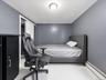 Interior room featuring light gray wall paint and white baseboards