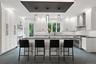 Kitchen with Quartz countertops, stainless steel appliances, wine fridge, and walk-in pantry
