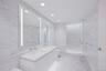 Primary Bathroom Spa-inspired bathrooms feature Blue de Savoie stone floors, Calacatta Lincoln marble walls, oversized walk-in showers, and meticulous