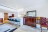 Breakfast Bar Featuring custom Italian white lacquer cabinetry, Calacatta Lincoln marble countertops, natural stone finishes with waterfall edges