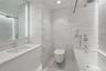 Secondary Bedroom Ensuite bathroom.  Spa-inspired bathrooms feature Blue de Savoie stone floors, Calacatta Lincoln marble wallsand meticulously crafte