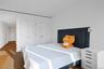 Second Bedroom Bright interior space featuring a white wall, wood-finish flooring, recessed lighting
