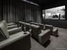 Dedicated theater featuring tiered seating, individual recliners with cupholders, a large projection screen located in Common Area on 2nd Floor