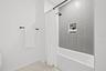Large curdles walk-in shower with two shower heads and wands